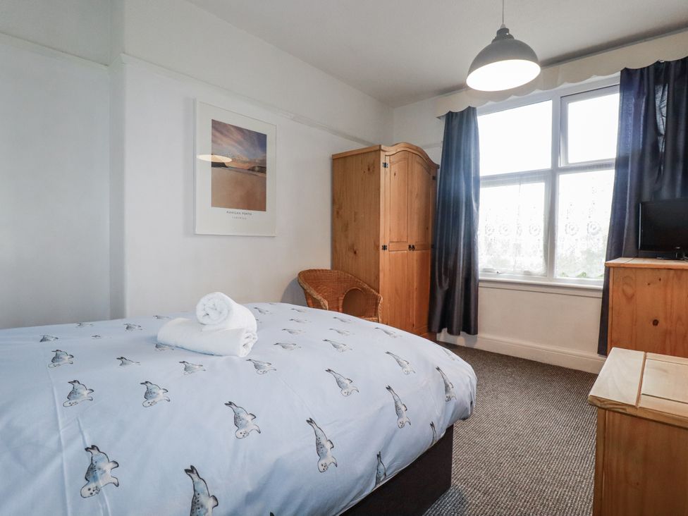 A bedroom with a bed and furniture at The Three Tees in Newquay