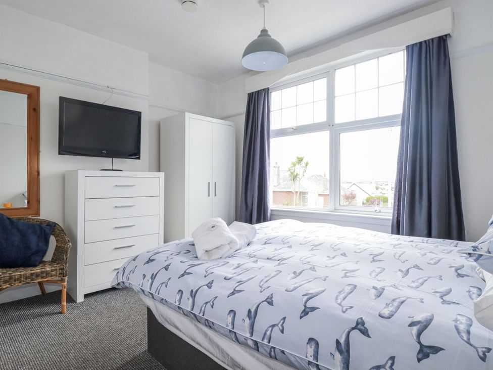 A bedroom with a bed and television at The Three Tees in Newquay