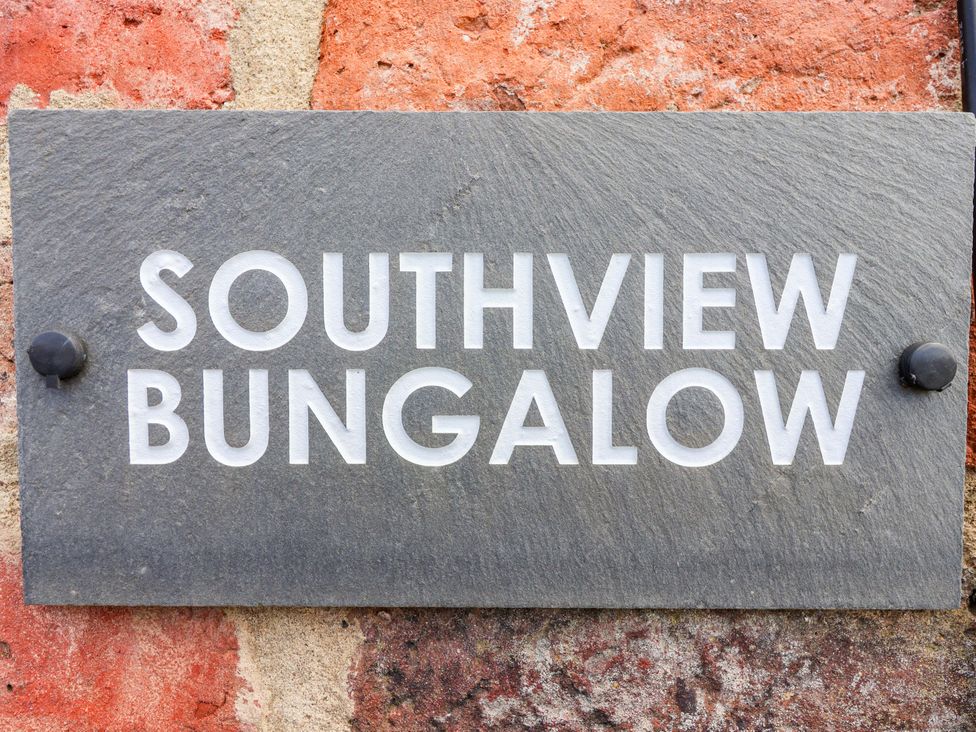 A sign displaying Southview Bungalow on a stone wall at Southview Bungalow in Barmston