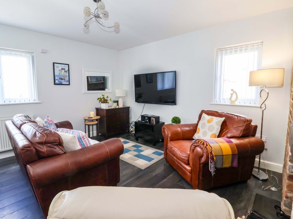 A living room with a sofa and armchair at Southview Bungalow in Barmston