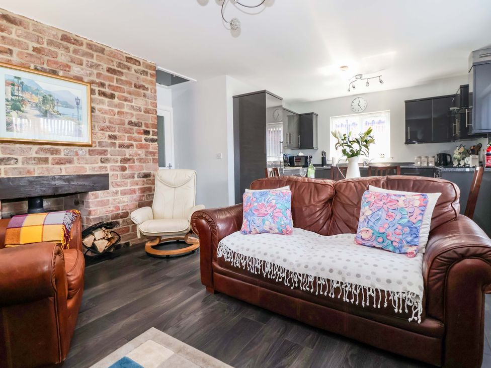 A living room with a sofa and chairs at Southview Bungalow in Barmston