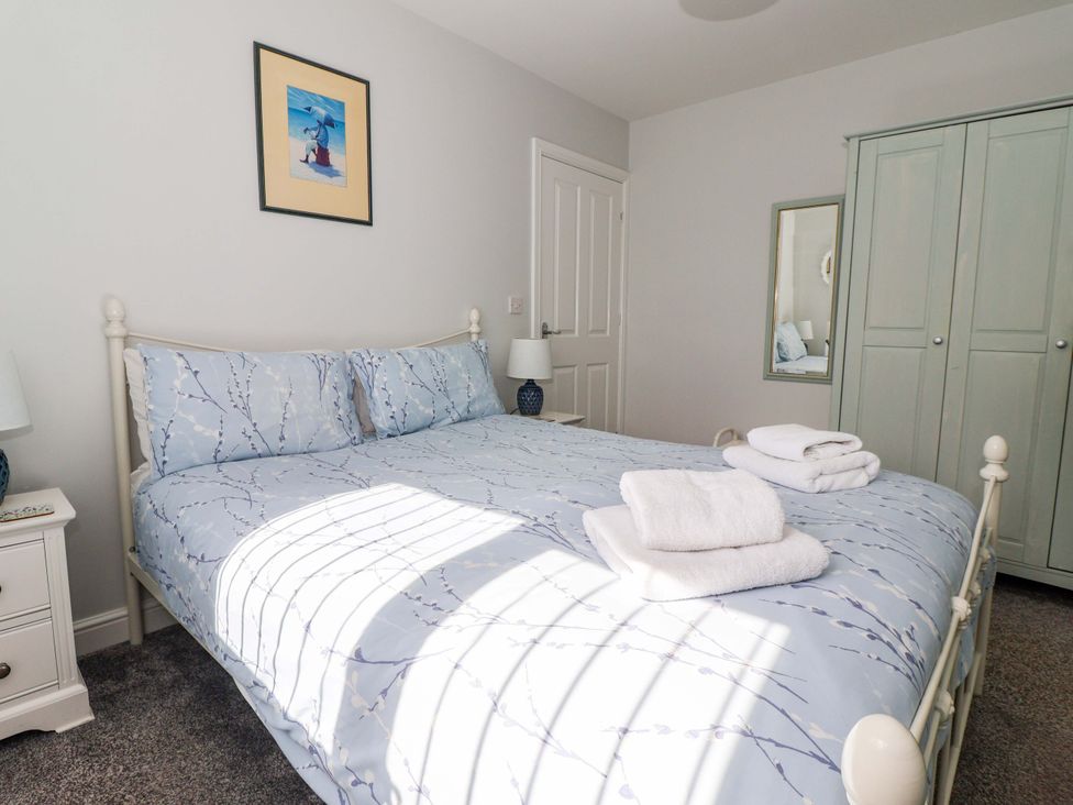 A bedroom with a bed and bedside table at Southview Bungalow in Barmston