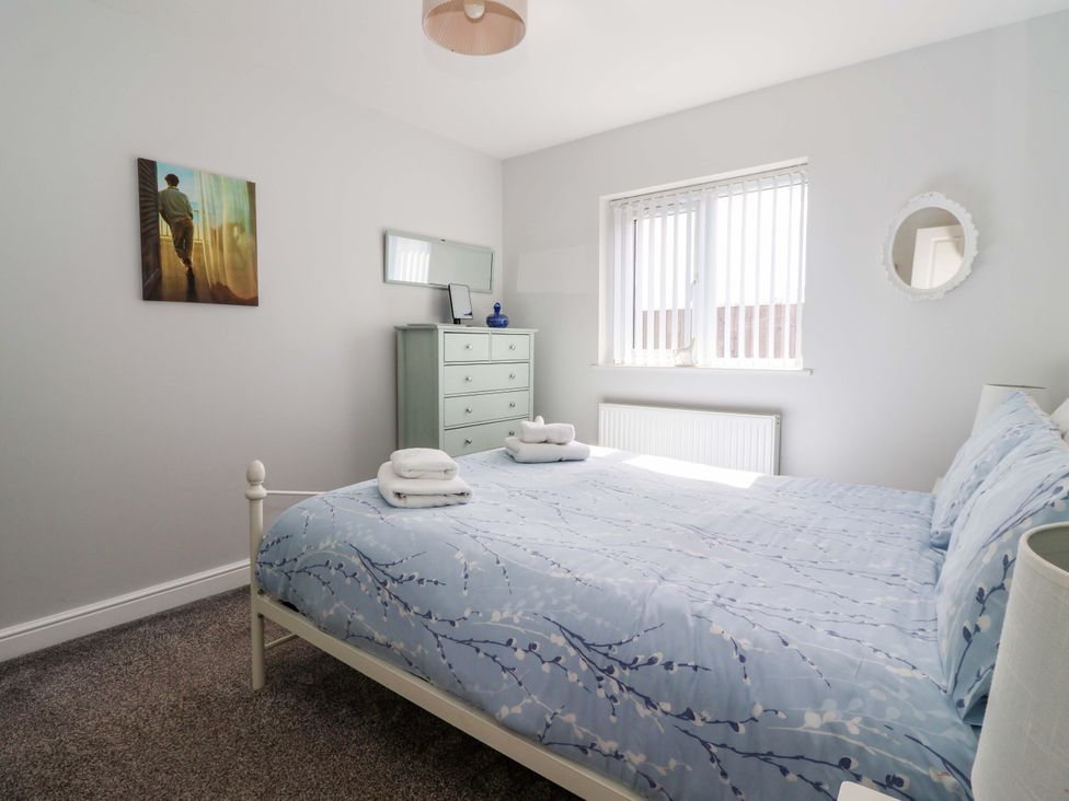A bedroom with a bed and dresser at Southview Bungalow in Barmston