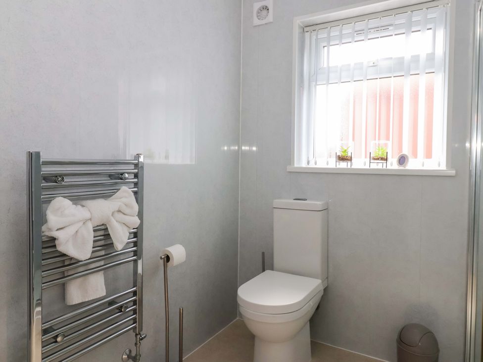 A bathroom with a toilet and towel rail at Southview Bungalow in Barmston
