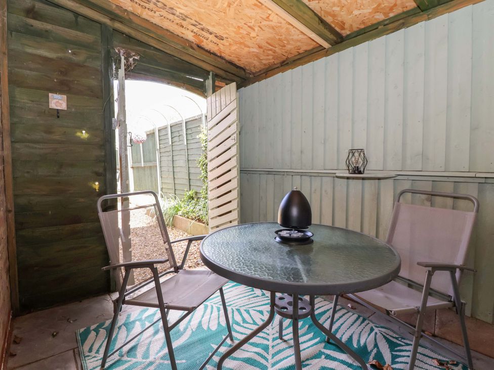 An outdoor shed with a table and chairs at Southview Bungalow in Barmston