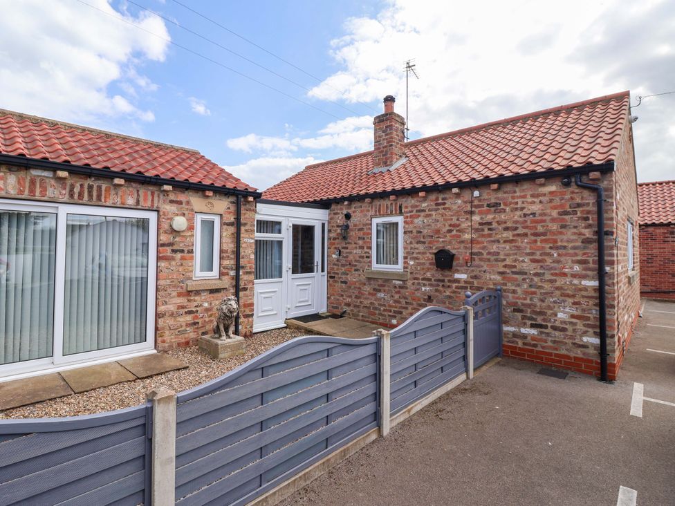 A house with a front door and driveway at Southview Bungalow in Barmston