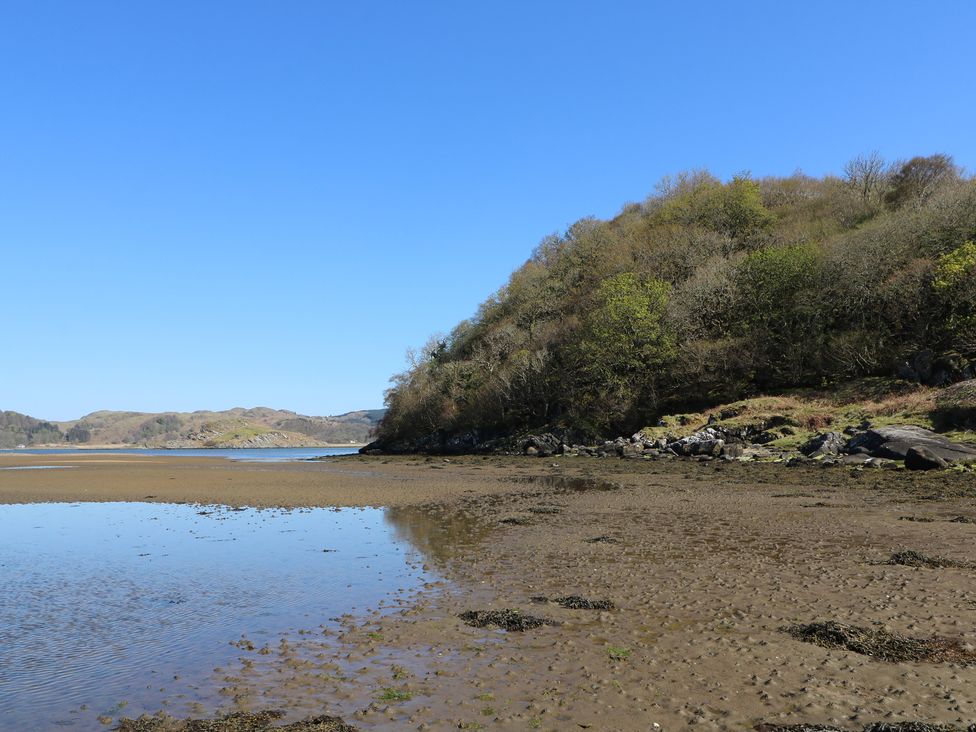 A beach area with water and a hill at Kilmartin View in Netherlargie Farm