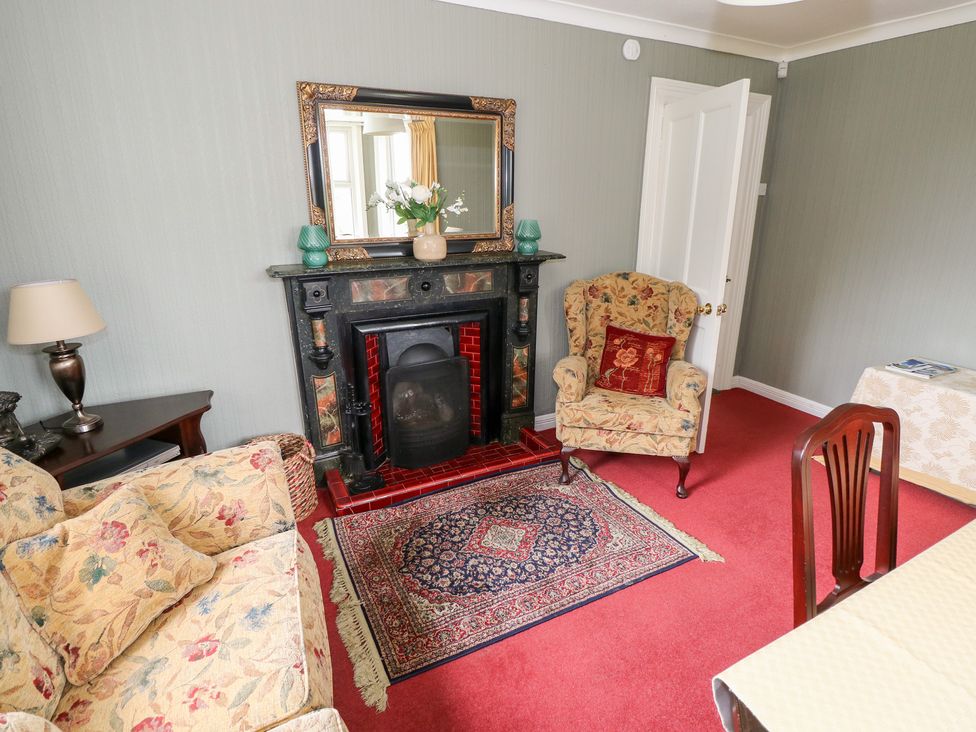 A living room with a fireplace and sofa at Churchfield House Moygownagh near Crossmolina, County Mayo