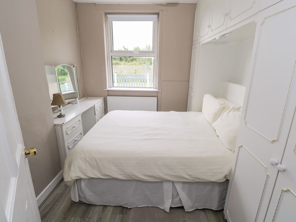 A bedroom with a bed and dresser at Churchfield House Moygownagh near Crossmolina, County Mayo