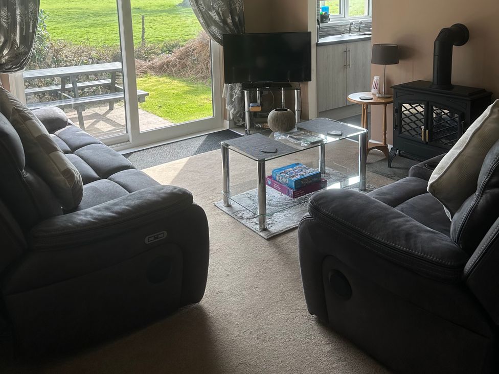 A living room with sofas and a coffee table at Watergate Bay in Liskeard
