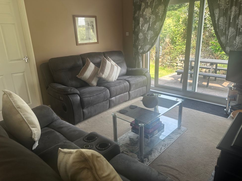 A living room with a sofa and coffee table at Watergate Bay in Liskeard