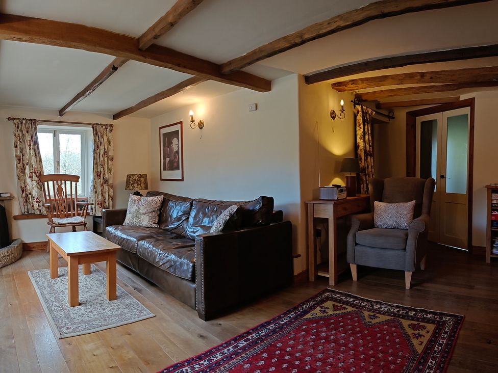 A living room with a sofa and coffee table at Green Farm Stables in Hognaston near Carsington Water