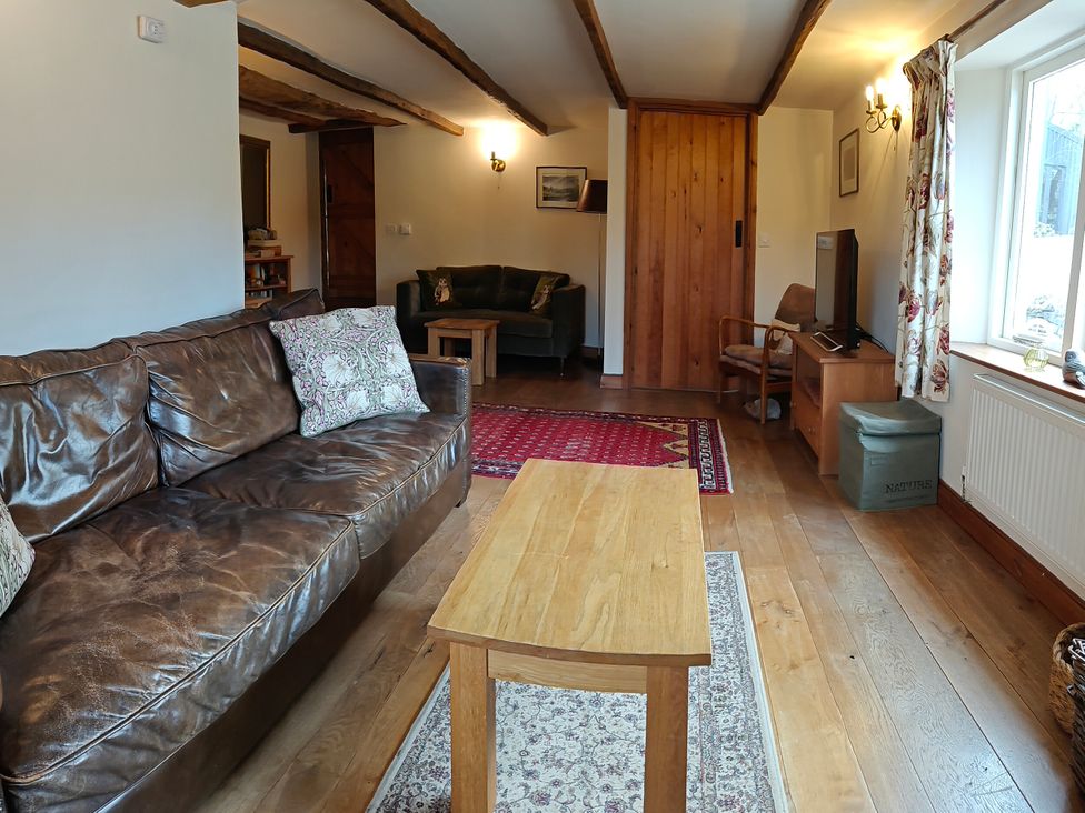 A living room with a sofa and coffee table at Green Farm Stables in Hognaston near Carsington Water