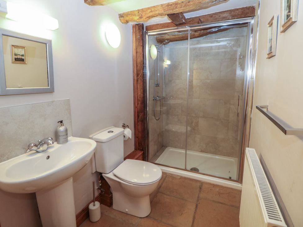 A bathroom with a sink, toilet, and shower at Green Farm Stables in Hognaston near Carsington Water