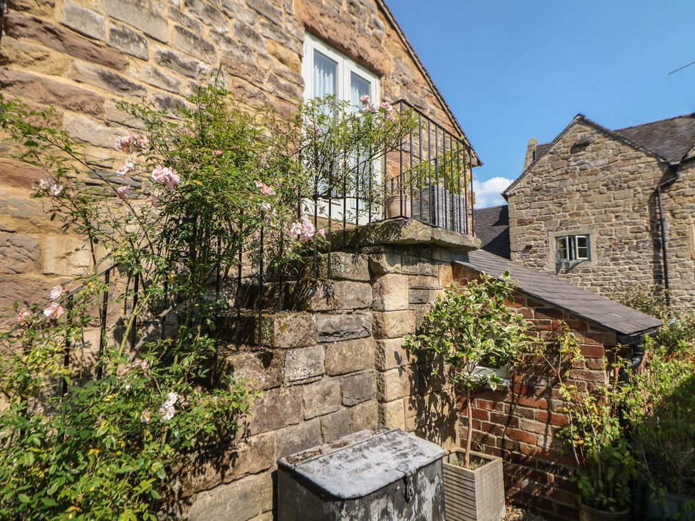 An outdoor area with flowers and stone walls at Green Farm Stables Hognaston near Carsington Water