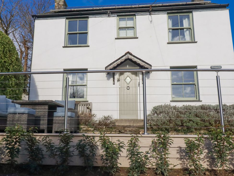 A house with a front door and patio furniture at Tresawle in Crantock