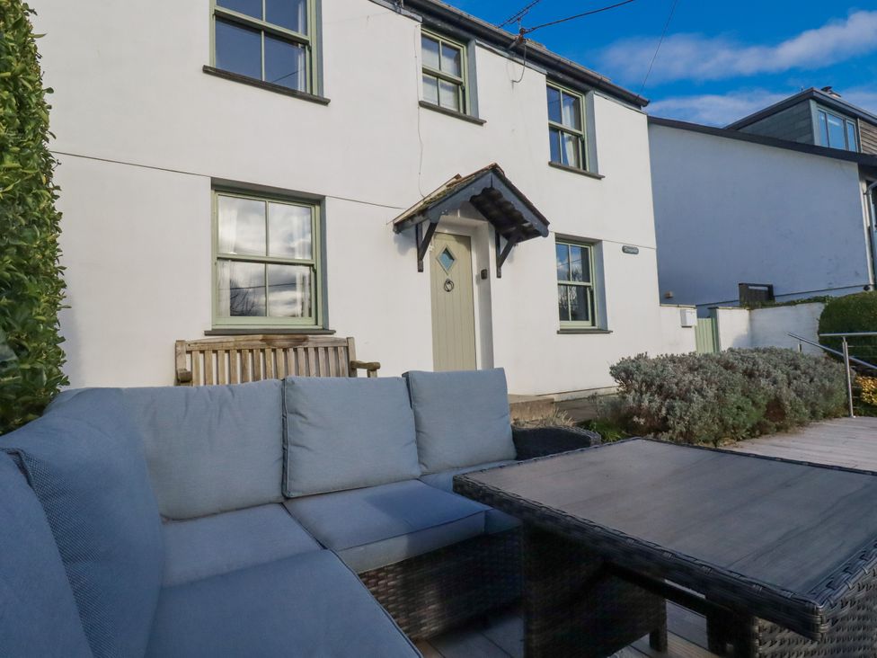 An outdoor area with a seating arrangement and a house at Tresawle in Crantock