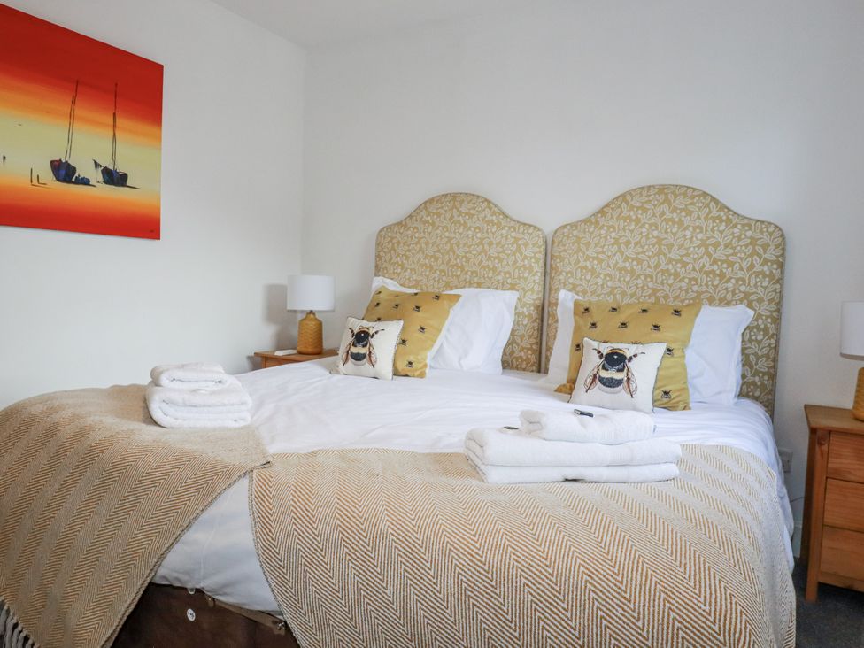 A bedroom with a bed and bedside table at Tresawle in Crantock