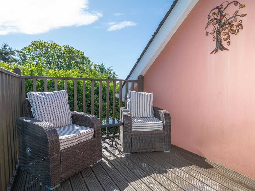 An outdoor patio with chairs and a table at Garden View Apartment in Kingsbridge