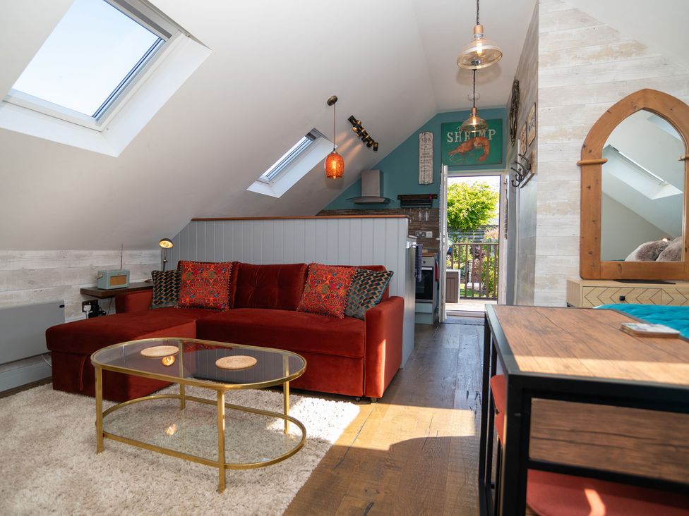 A living room with a sofa and coffee table at Garden View Apartment in Kingsbridge