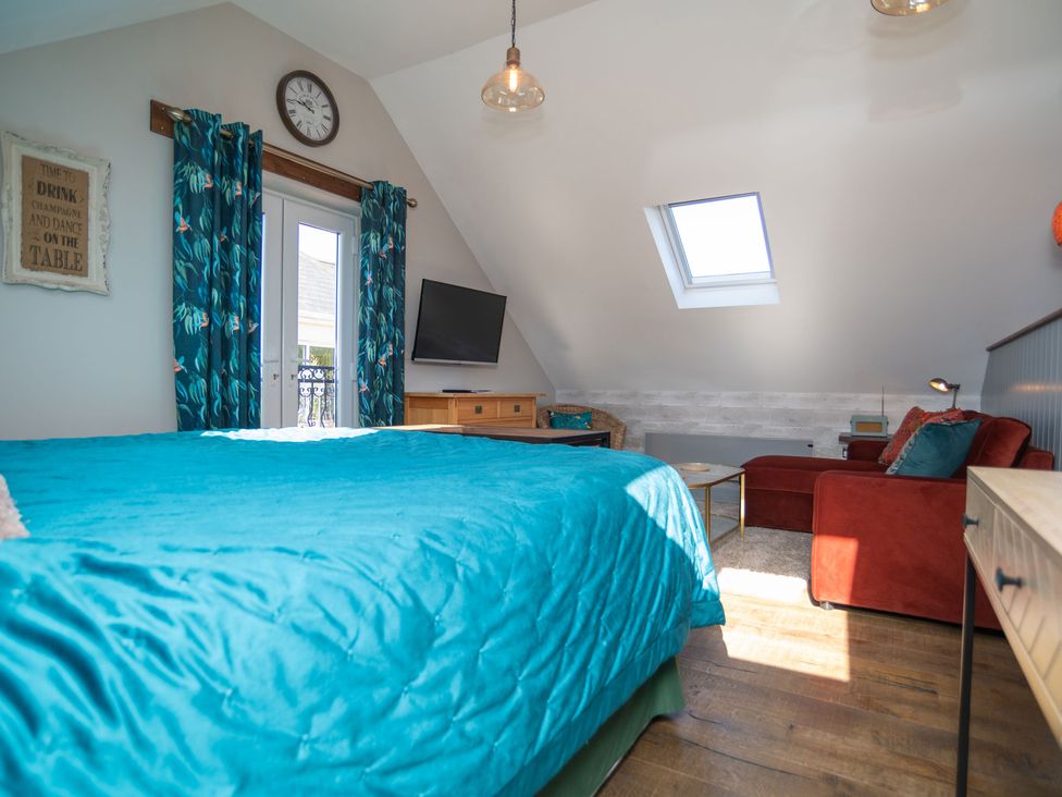 A bedroom with a bed and television at Garden View Apartment in Kingsbridge
