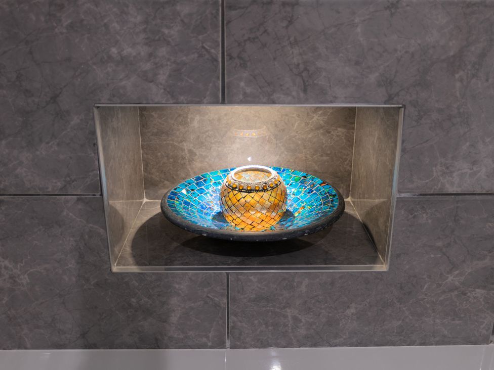 A decorative bowl on a shelf in a bathroom at Garden View Apartment in Kingsbridge