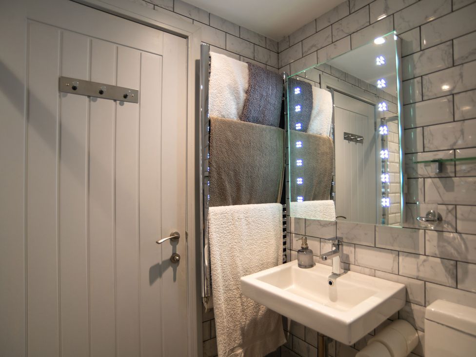 A bathroom with a sink and towels hung at Garden View Apartment in Kingsbridge