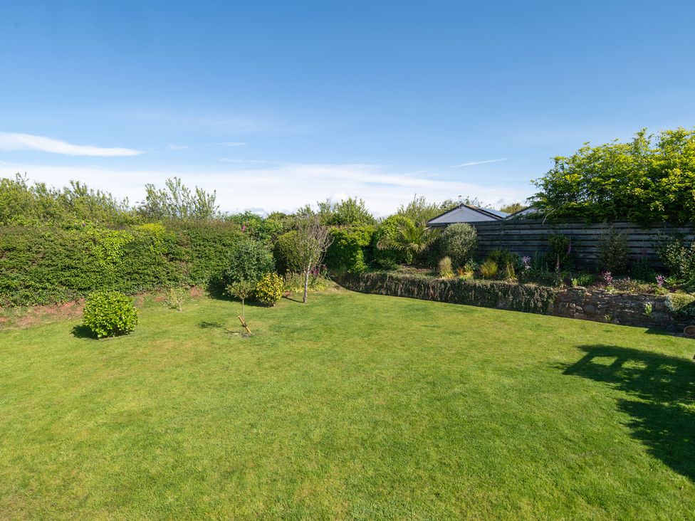 A garden with grass and plants at Garden View Apartment in Kingsbridge