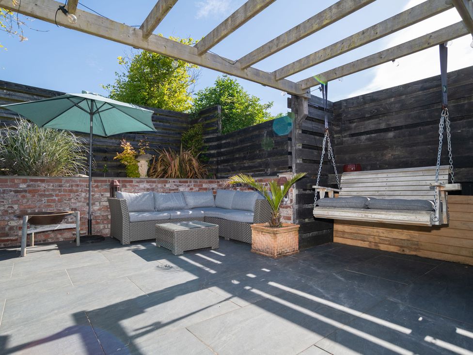 An outdoor patio with seating and plants at Garden View Apartment in Kingsbridge