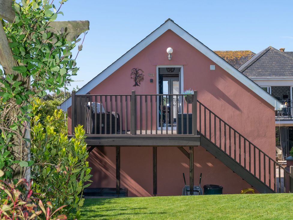 A house with a deck and stairs at Garden View Apartment in Kingsbridge
