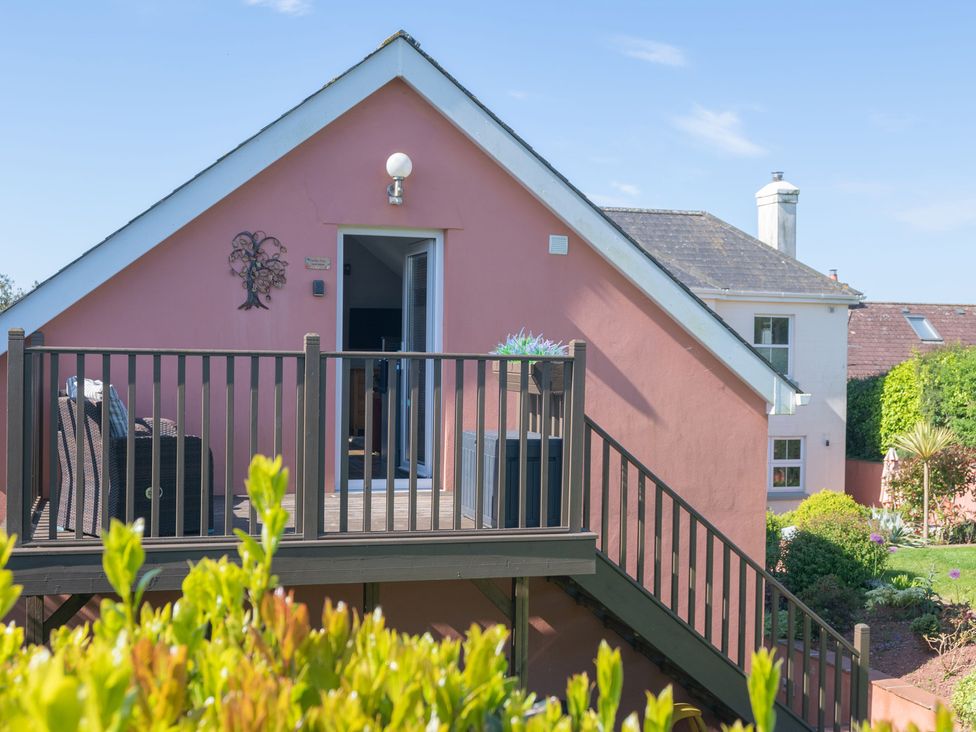 A house with a deck and outdoor furniture at Garden View Apartment in Kingsbridge