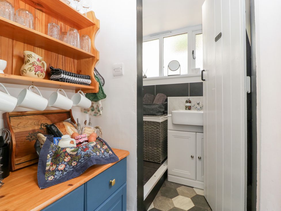 A kitchen with shelves and a sink at Avonmede Tewkesbury