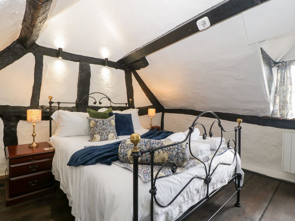 A bedroom with a bed and nightstand at Avonmede in Tewkesbury