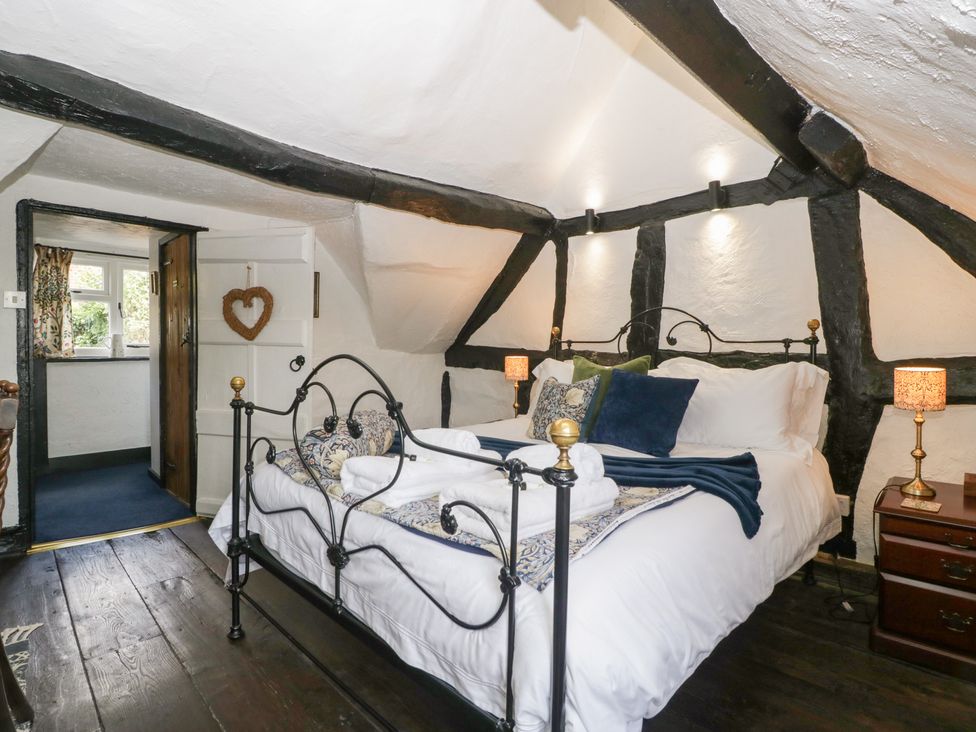 A bedroom with a bed and bedside table at Avonmede Tewkesbury