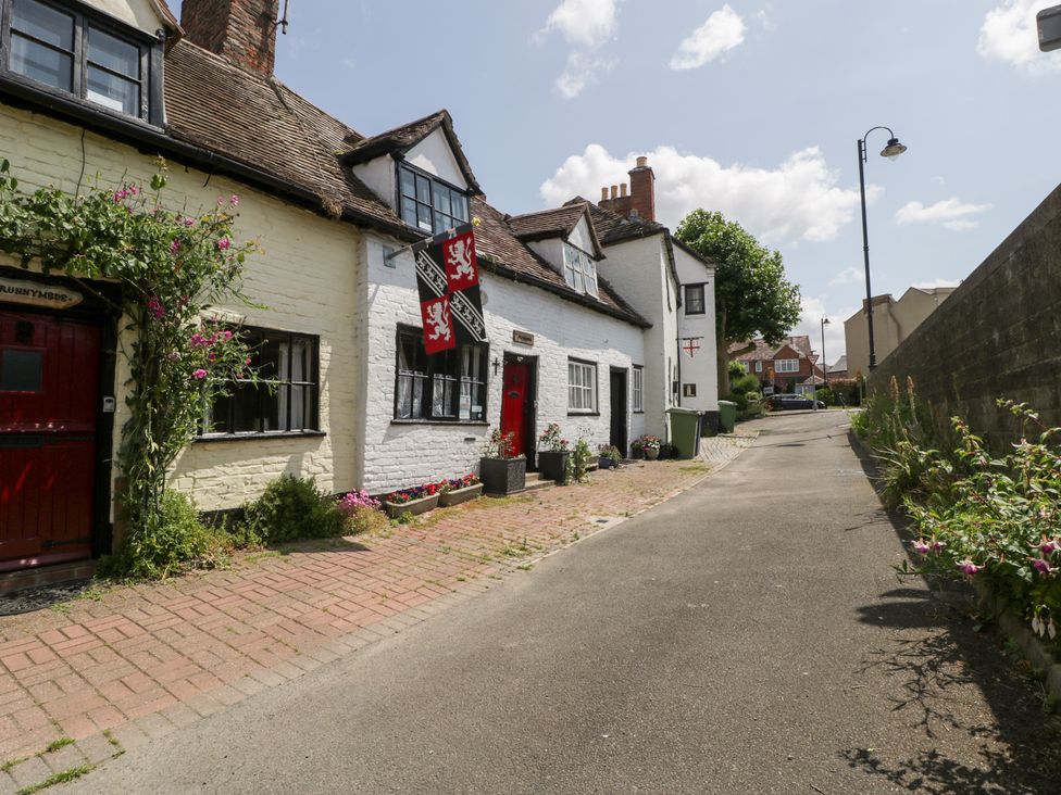 A street view of houses with brick path and plants at Avonmede Tewkesbury