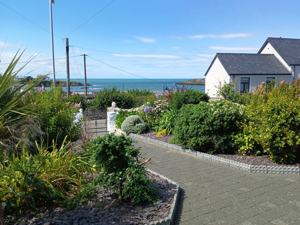 A garden view with sea in the background at The Old School House in Cemaes Bay