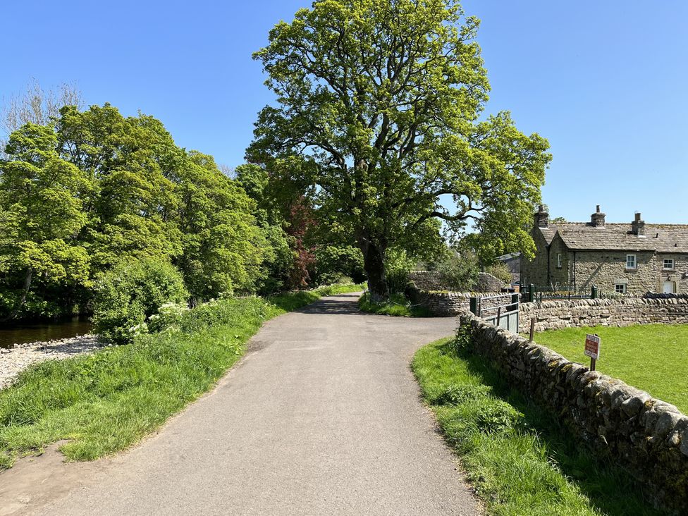 A road with trees and buildings at Bracken Cottage in Stanhope