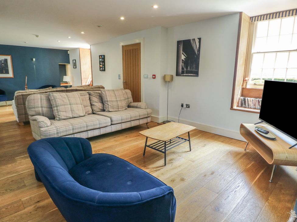 A living room with a sofa and armchair at Clynnog House Dwyran near Newborough