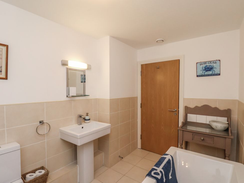 A bathroom with a sink and a bathtub at Sail Away, 17 Union Mill, Whitby