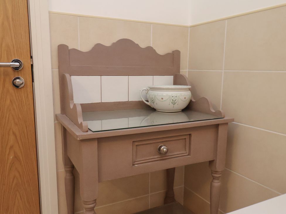A table with a bowl on top in a bathroom at Sail Away, 17 Union Mill, Whitby
