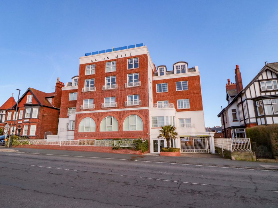 A building with windows and a fence at Sail Away, 17 Union Mill in Whitby
