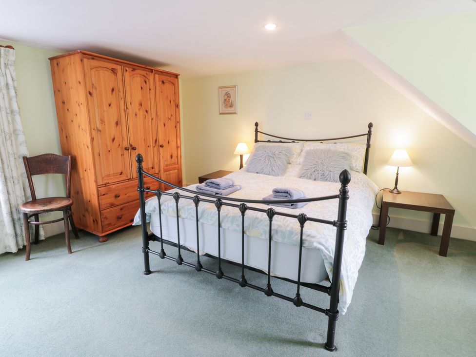 A bedroom with a bed and wardrobe at Strathannan in Moffat