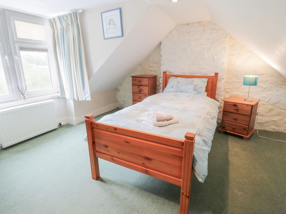 A bedroom with a bed and nightstands at Strathannan in Moffat