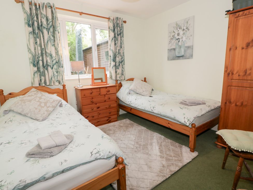 A bedroom with two beds and a dresser at Strathannan in Moffat
