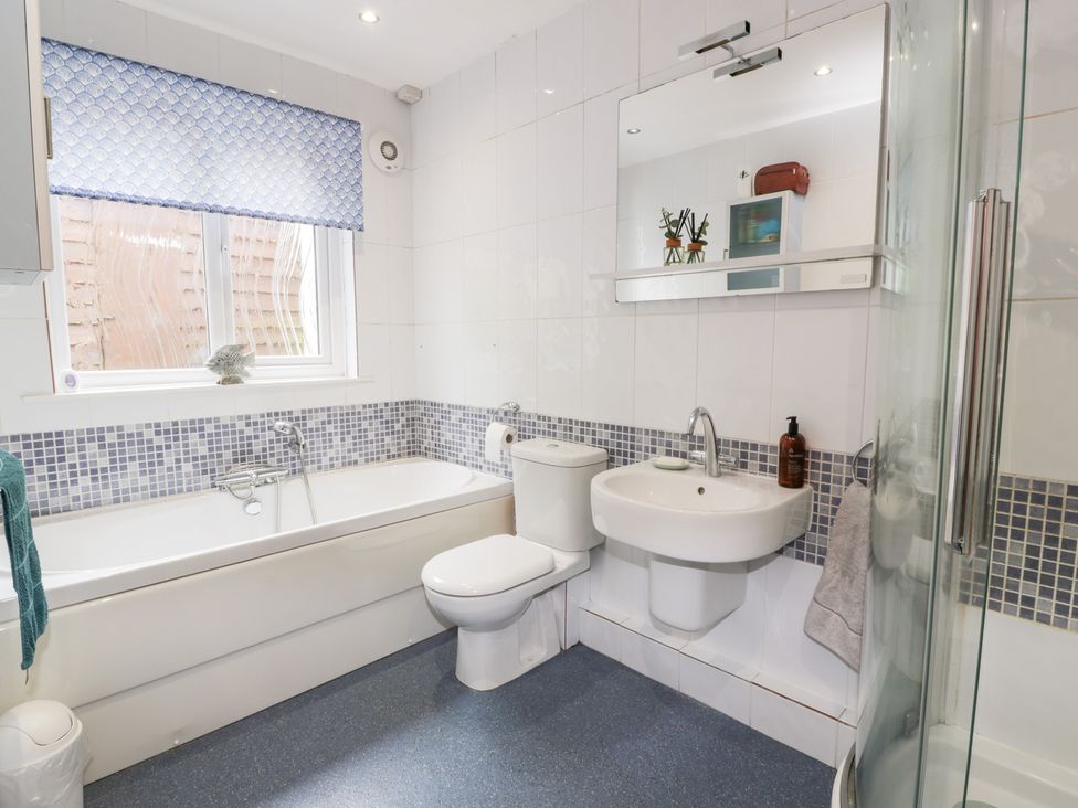A bathroom with a bathtub and shower at Strathannan in Moffat