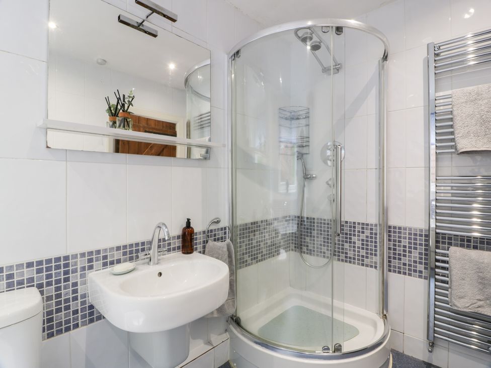 A bathroom with a shower, sink, and toilet at Strathannan in Moffat
