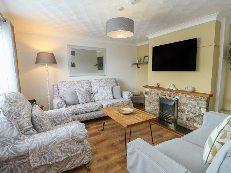 A living room with sofas and a coffee table at Glasfryn in Holyhead