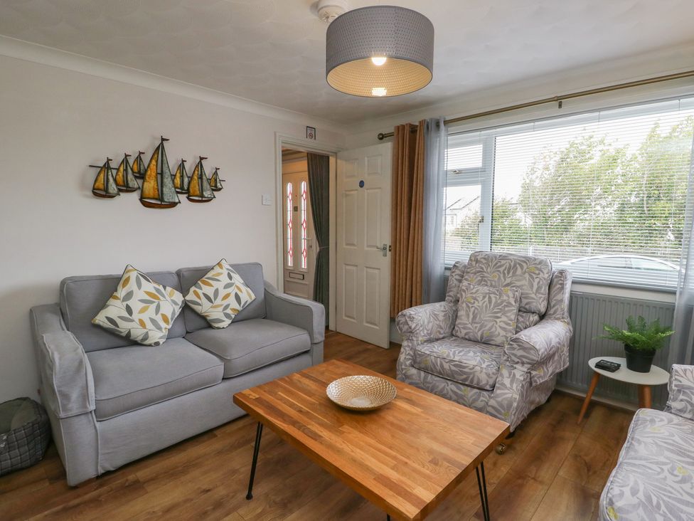 A living room with a sofa and a coffee table at Glasfryn in Holyhead