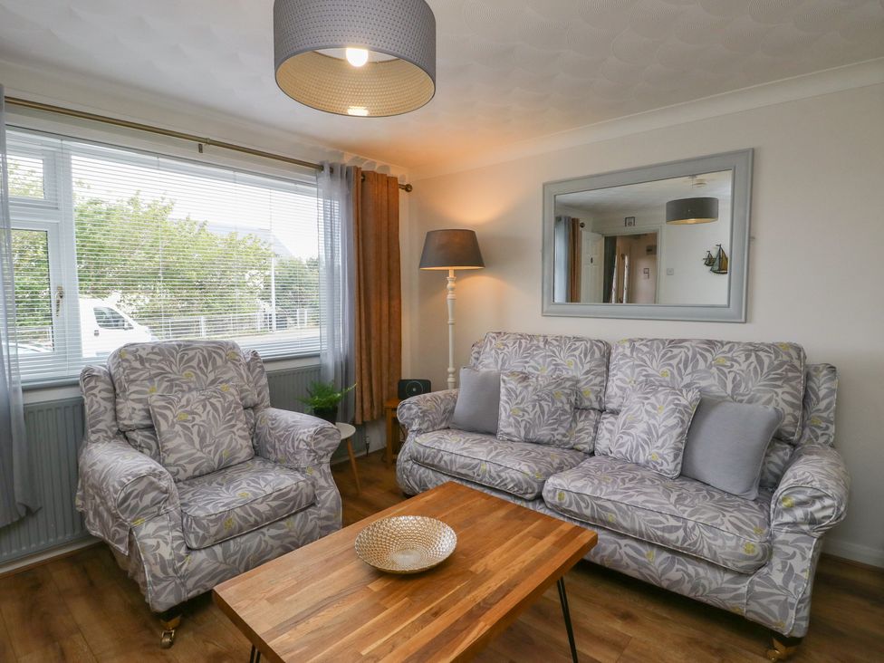 A living room with a sofa and armchair at Glasfryn in Holyhead