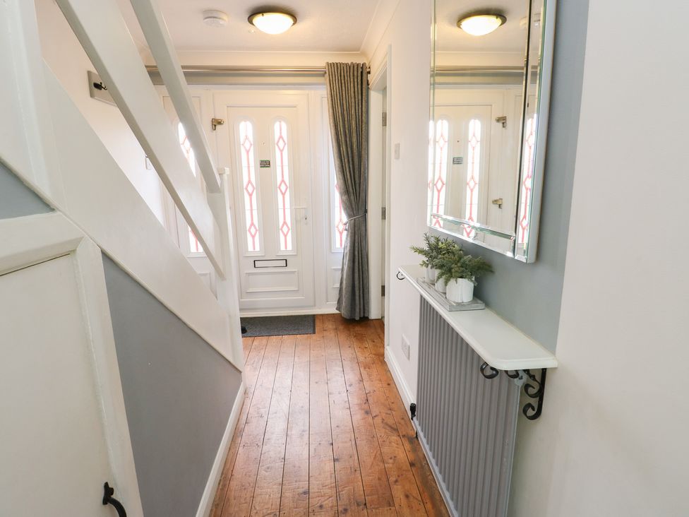 A hallway with front door and shelf at Glasfryn in Holyhead